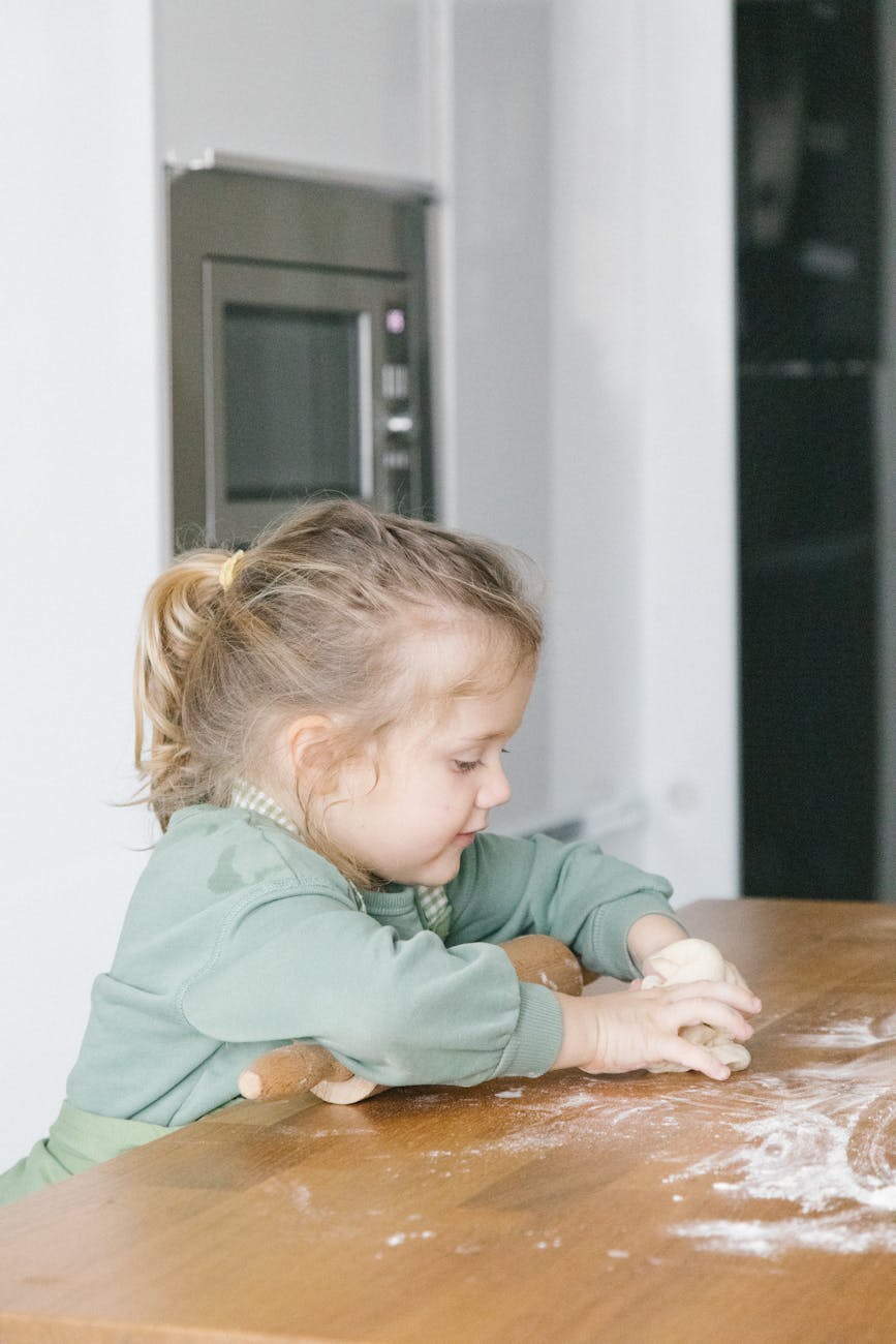 a girl kneading a dough
