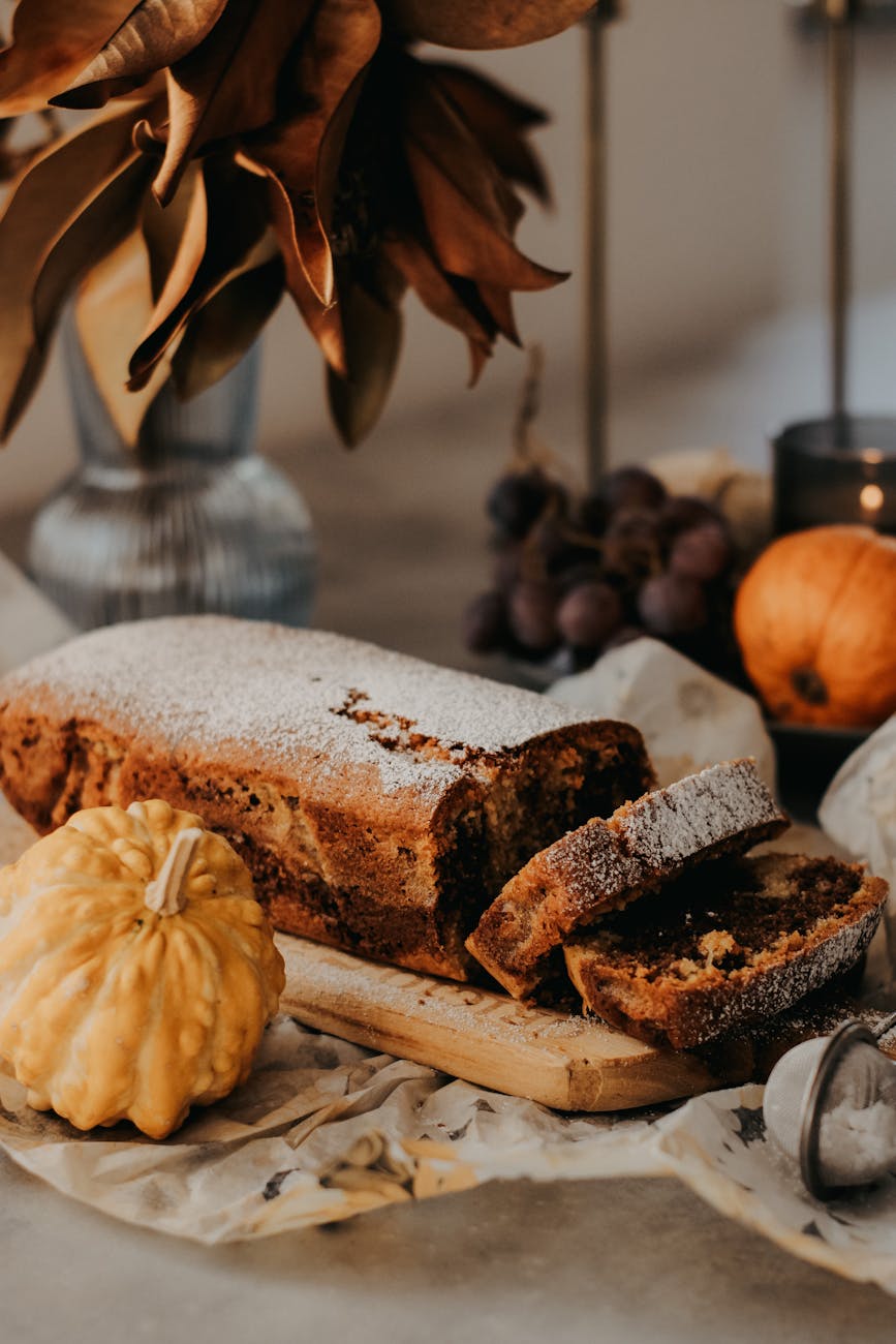 a loaf of bread with pumpkins and other fall decorations