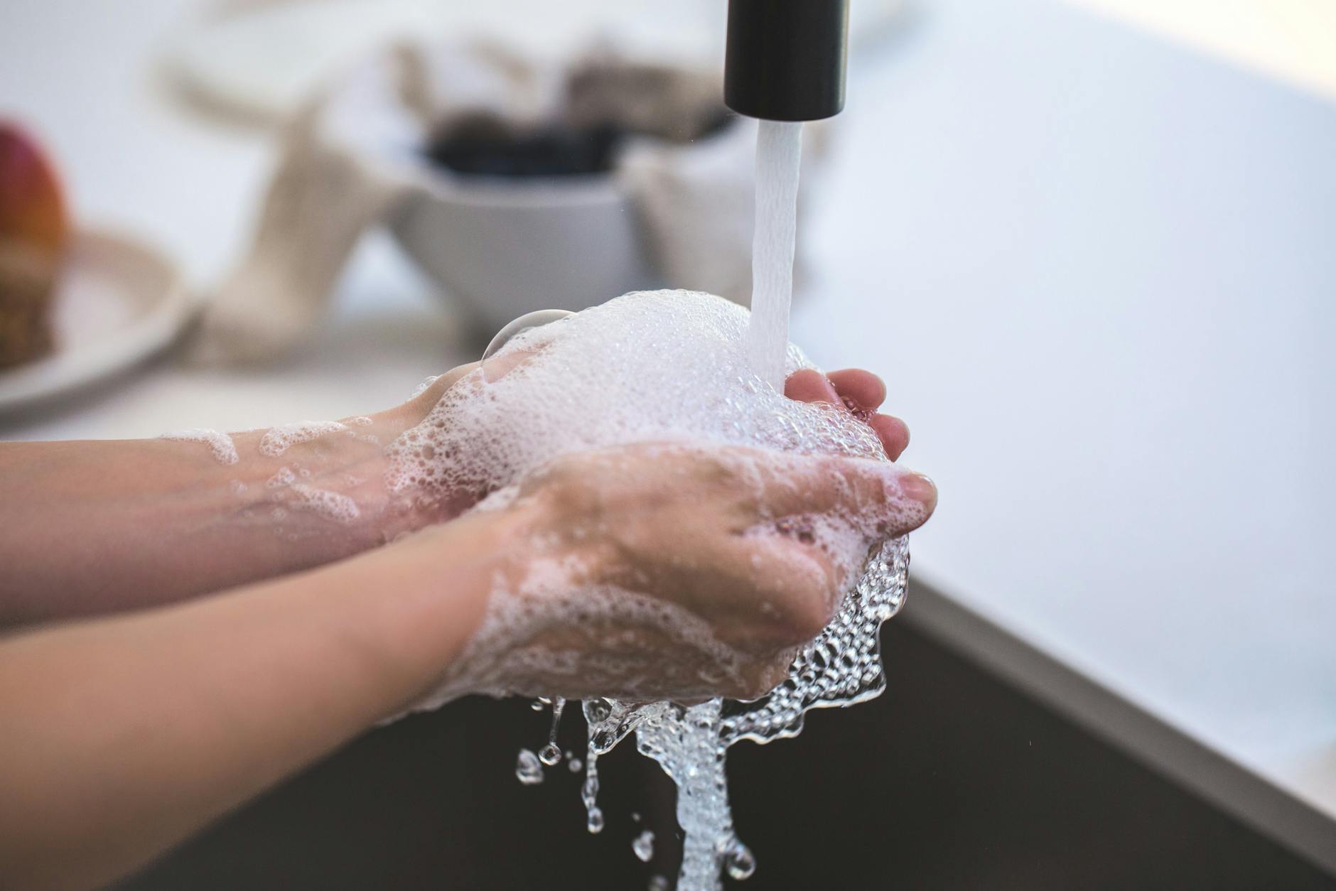 person washing his hand- a lifestyle factor that affects kids immunity, washing hands is an immune booster for kids