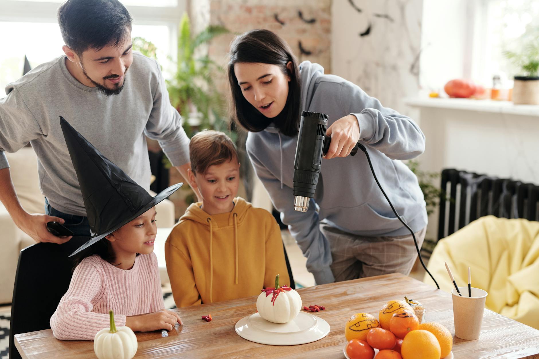 a family looking at a painted halloween pumpkin