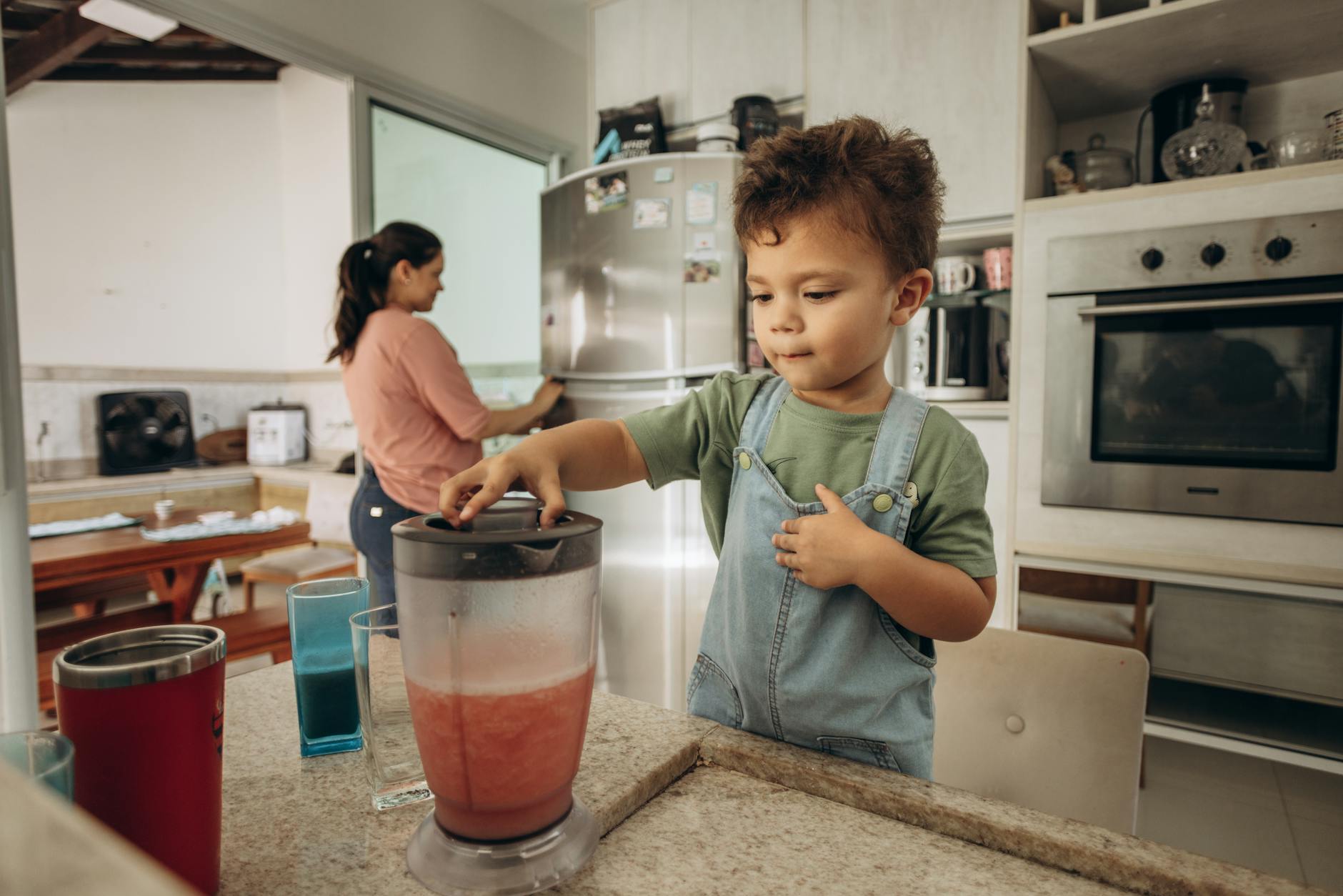 boy with blender in kitchen
