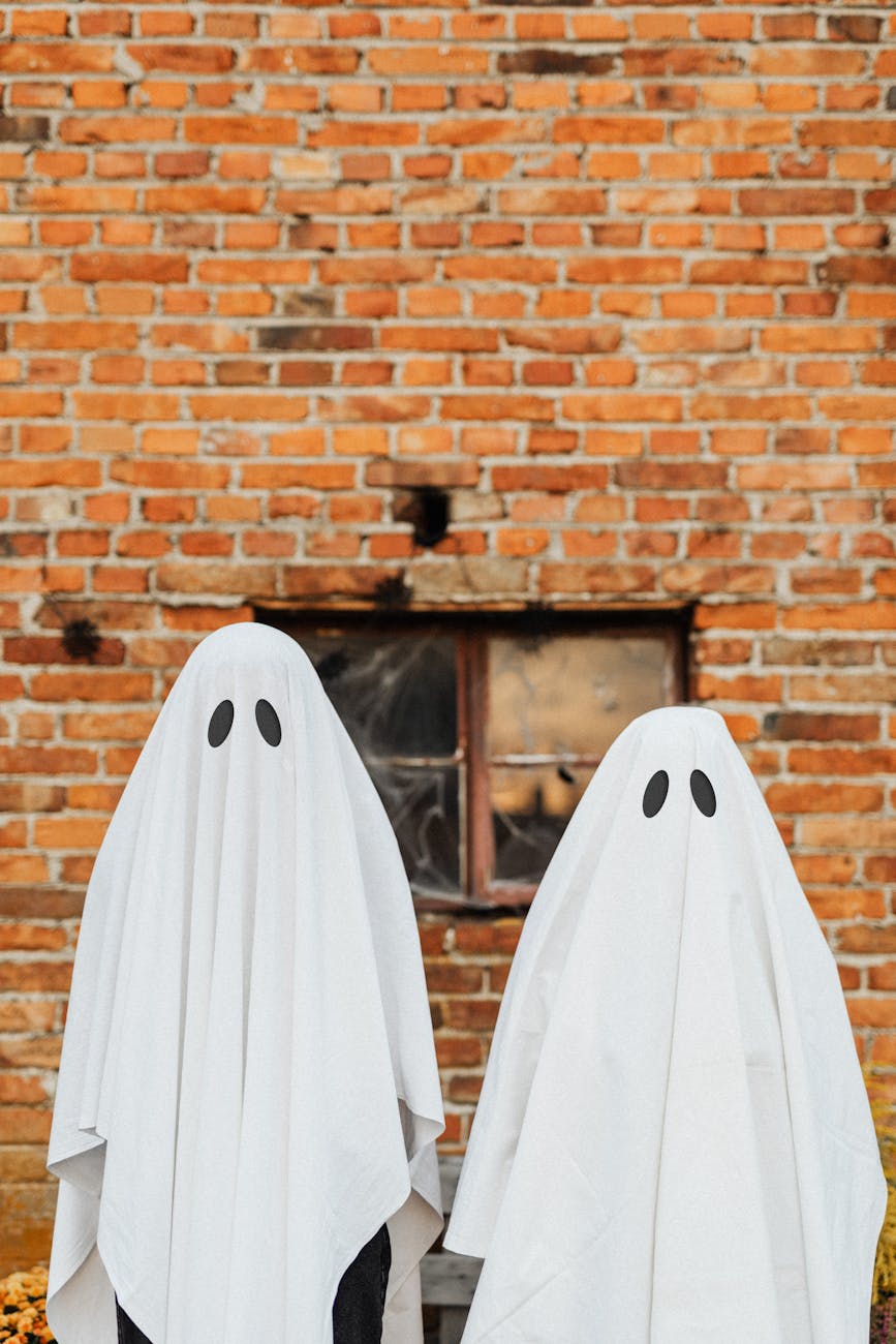 ghosts in front of a brick wall