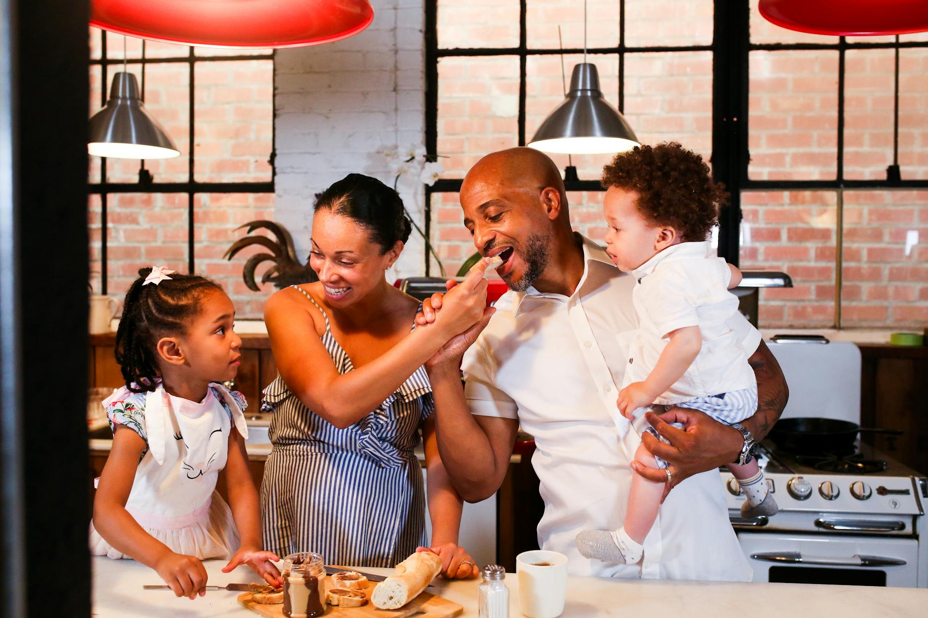 a happy family eating together in a kitchen