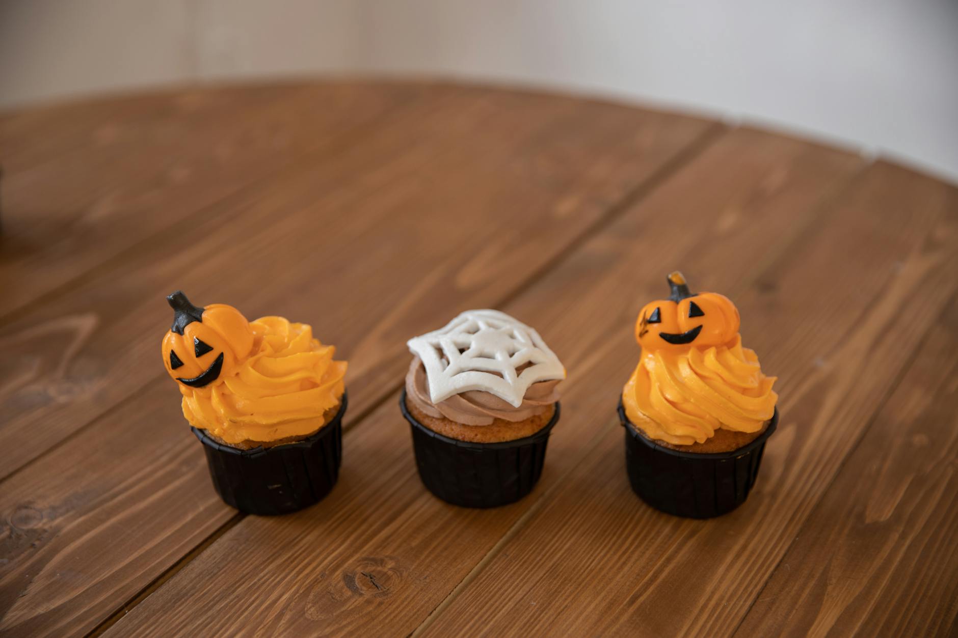 three halloween cupcakes on brown wooden table- halloween treats, gluten free halloween treats
