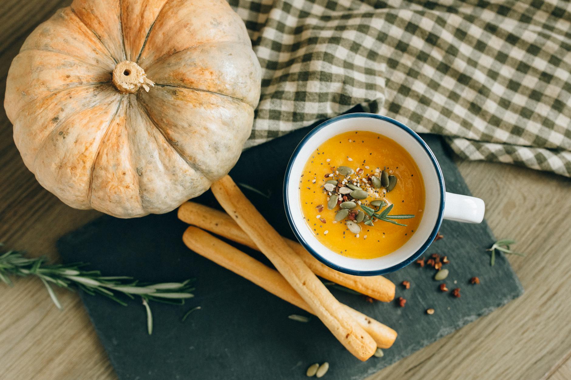 overhead shot of bread sticks and pumpkin soup