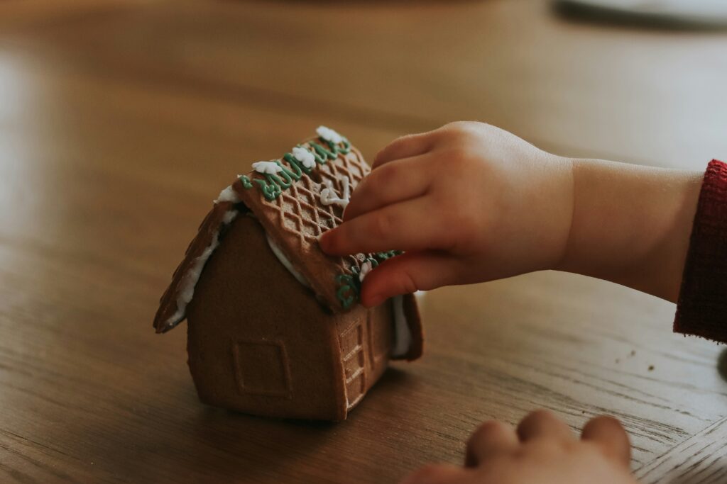 Young child helping with a small holiday task at home, showing how family routines naturally grow into Christmas traditions for toddlers.